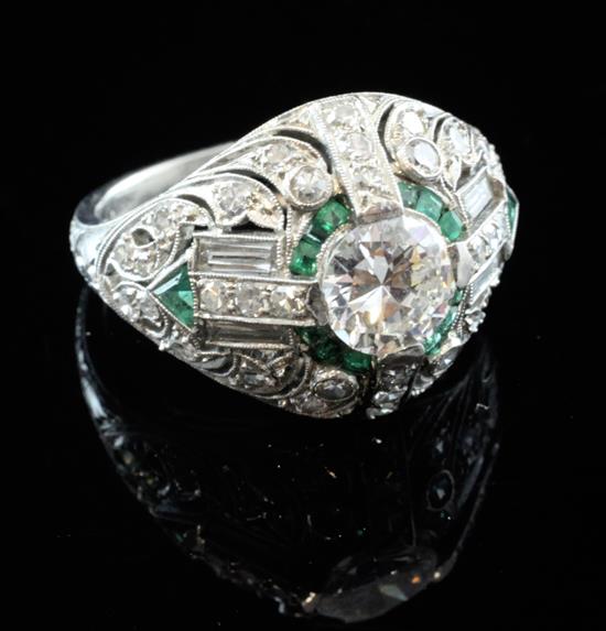 An Art Deco style platinum and iridium, emerald and diamond cluster dress ring, size N.